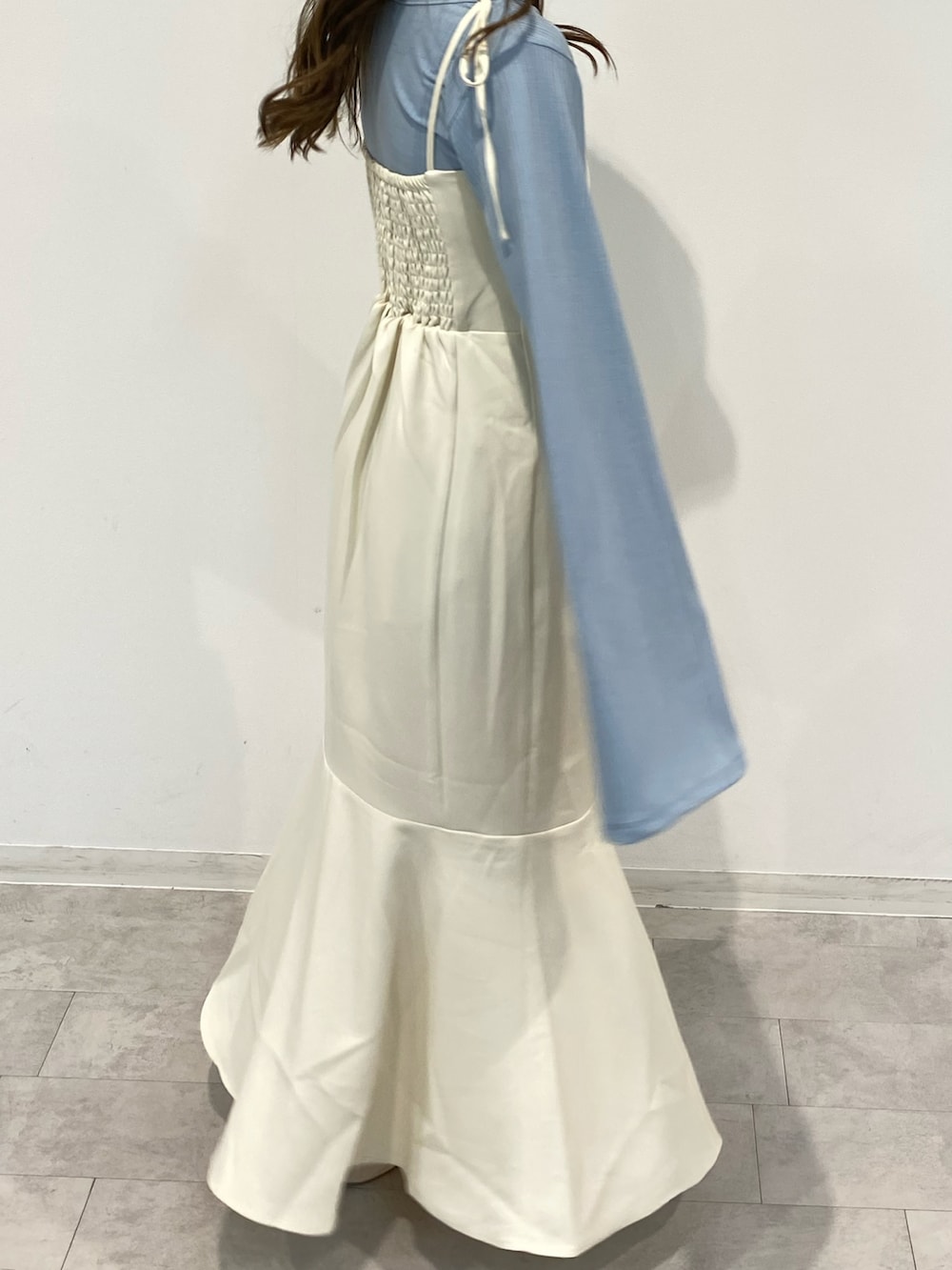 ホワイト系のワンピース、ブルー系のトップス、ホワイト系のバレエシューズを着用したレディースの春コーディネートの5枚目の写真