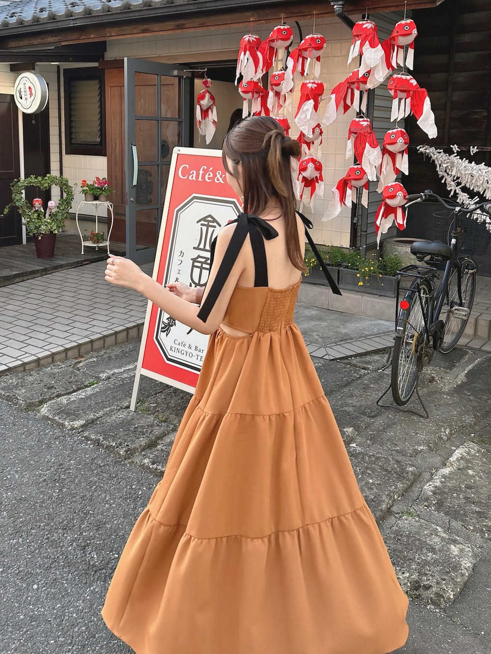 オレンジ系のワンピース/ドレスを着用したレディースの夏コーディネートの3枚目の写真