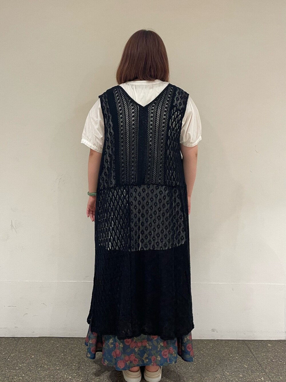 ホワイト系のチュニック、ブラック系のワンピース、ブルー系のスカートを着用したレディースの夏コーディネートの3枚目の写真