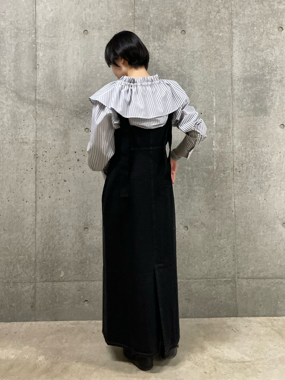 ホワイト系のシャツ/ブラウス、ブラック系のジャンパースカートを着用したレディースの春コーディネートの3枚目の写真