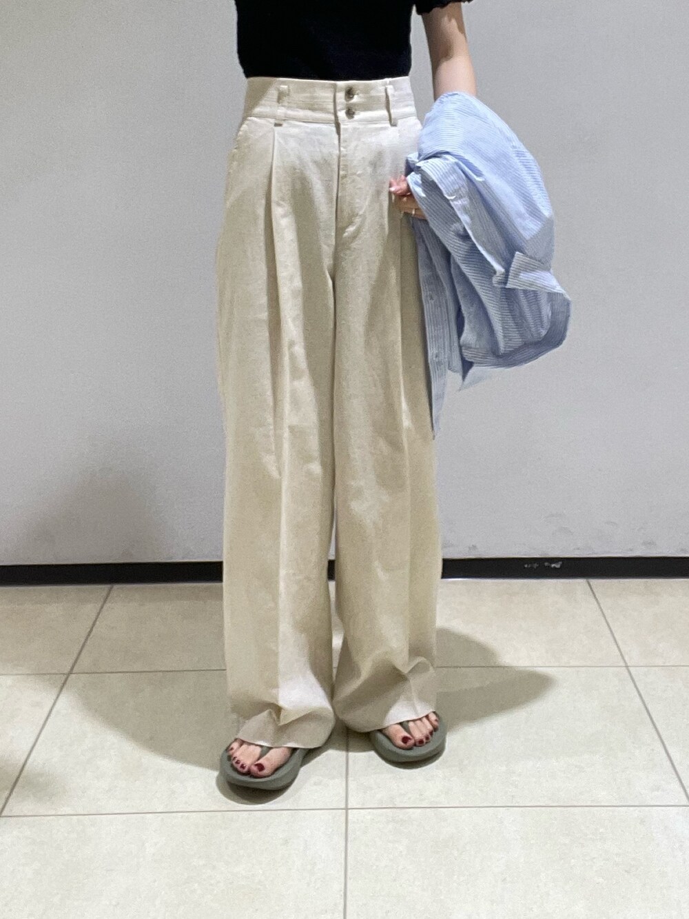 ブルー系のシャツ/ブラウス、ブラック系のTシャツ/カットソー、ベージュ系のスラックスを着用したレディースの夏コーディネートの6枚目の写真