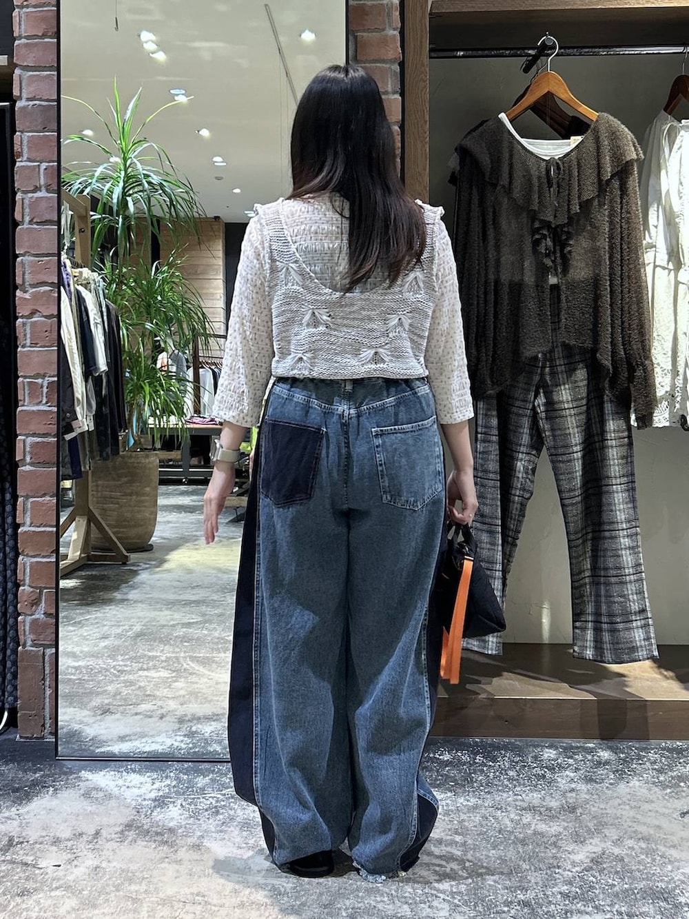 ホワイト系のTシャツ/カットソー、ホワイト系のベスト、ブラック系のトートバッグを着用したレディースの秋コーディネートの6枚目の写真