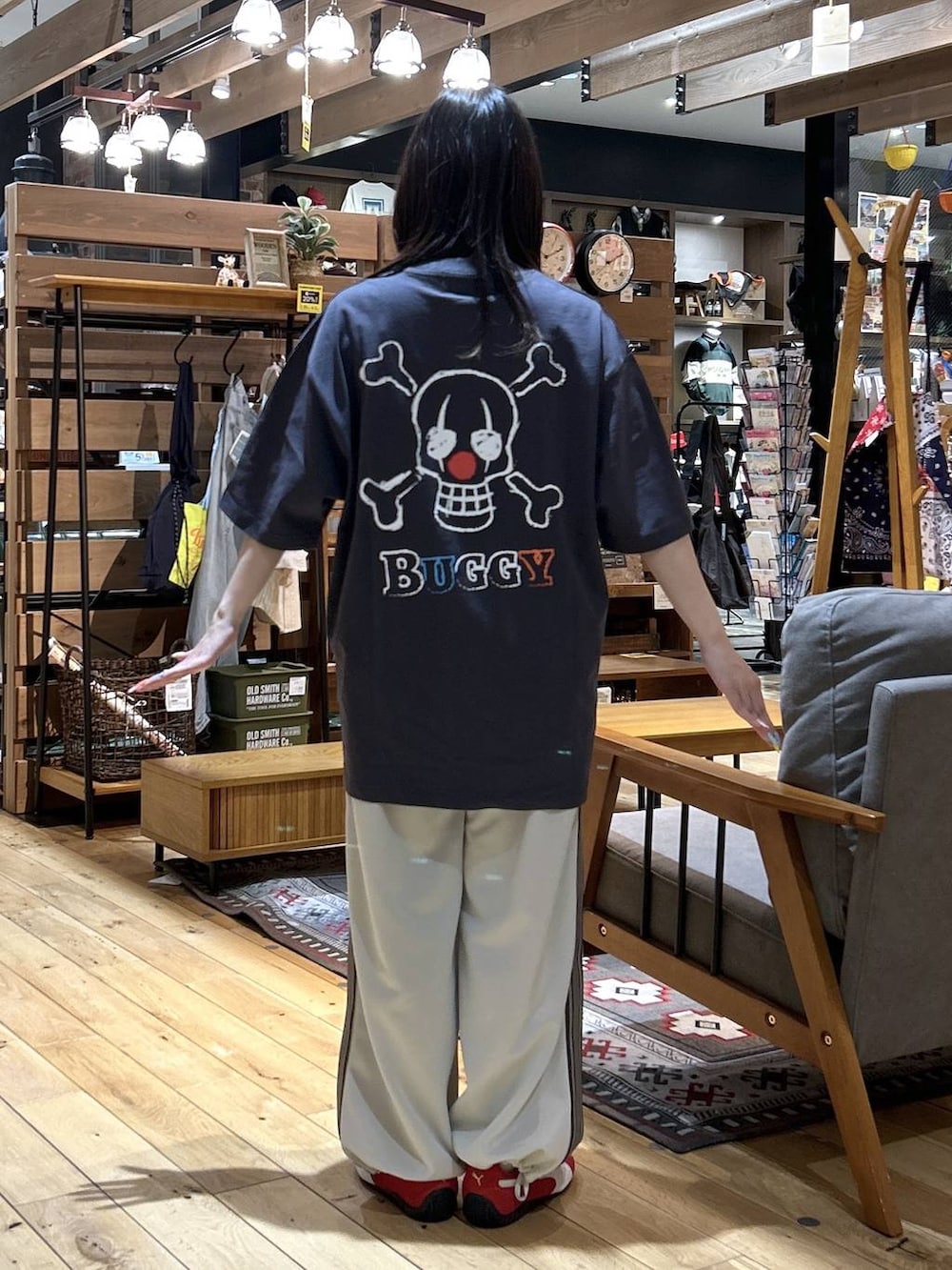 レッド系のスニーカー、ブラック系のショルダーバッグ、ベージュ系のカバーオールを着用したレディースの春コーディネートの8枚目の写真