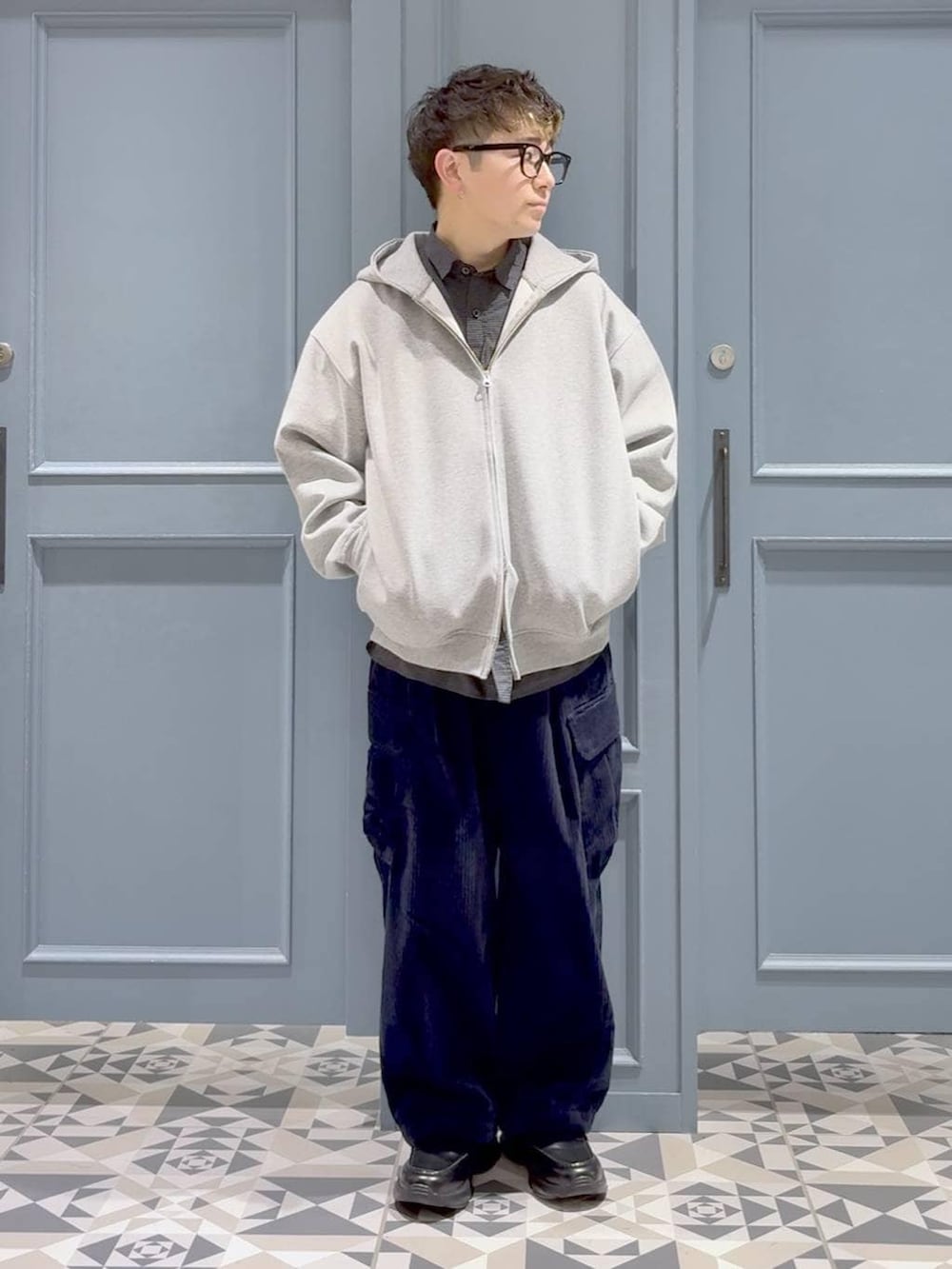 ブルー系のカーゴパンツ、ブラック系のローファー、ブラック系のシャツ/ブラウスを着用したメンズの冬コーディネートの4枚目の写真