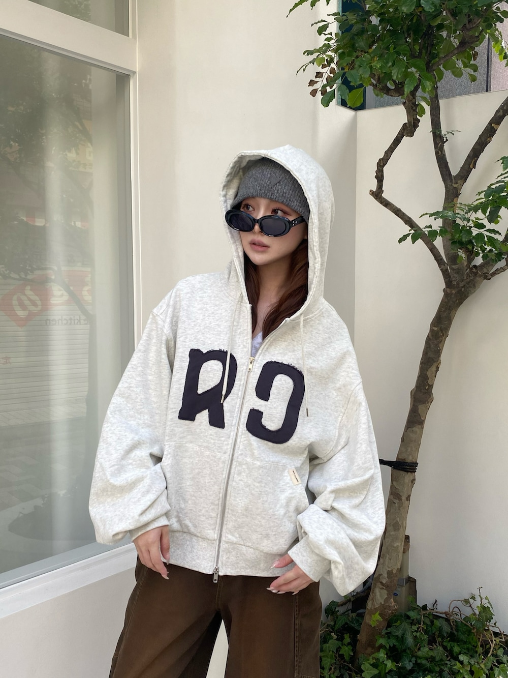 ホワイト系のパーカー、ブラウン系のデニムパンツ、ベージュ系のその他シューズを着用したレディースの秋コーディネートの2枚目の写真