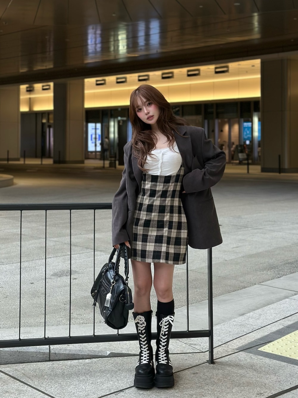 ブラック系のブーツ、ベージュ系のワンピース/ドレスを着用したレディースの春コーディネートの2枚目の写真