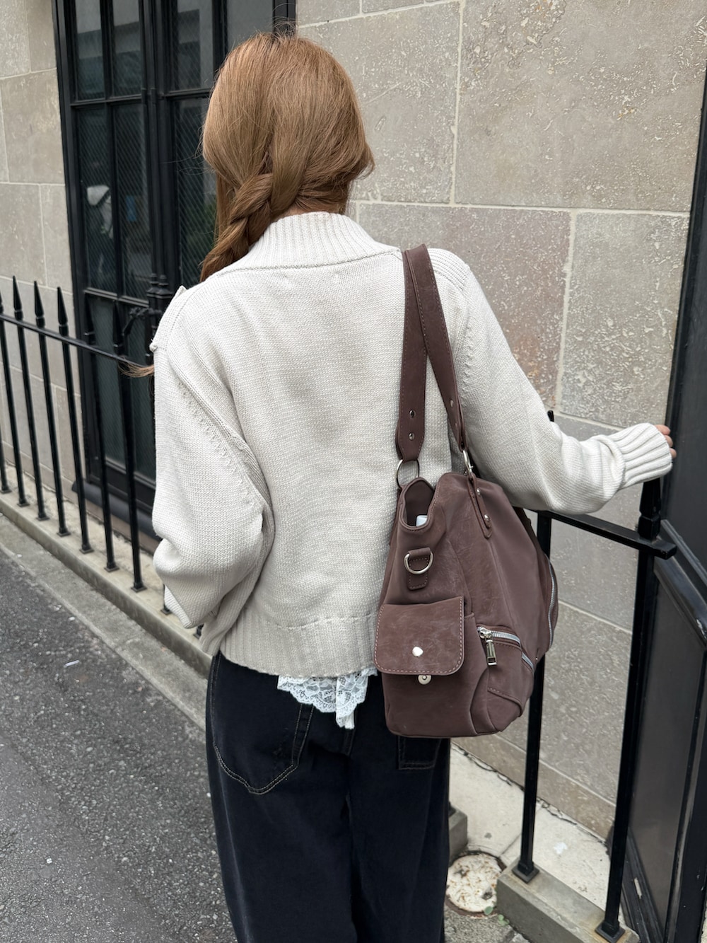 ブラック系のデニムパンツ、ブラック系のパンプス、ブラウン系のトートバッグを着用したレディースの秋コーディネートの3枚目の写真