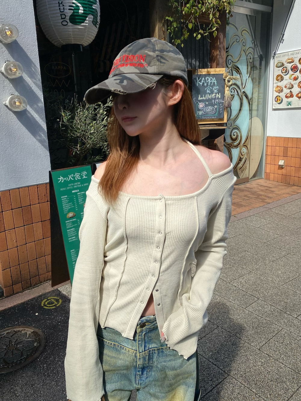 ベージュ系のTシャツ/カットソー、ブルー系のデニムパンツ、ブラック系のトートバッグを着用したレディースの春コーディネートの3枚目の写真