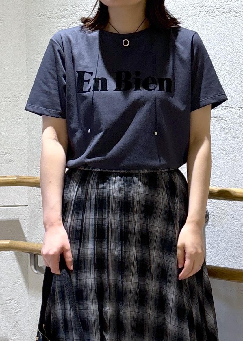 ゴールド系のサンダル、ブラック系のスカート、グレー系のTシャツ/カットソーを着用したレディースの夏コーディネートの5枚目の写真