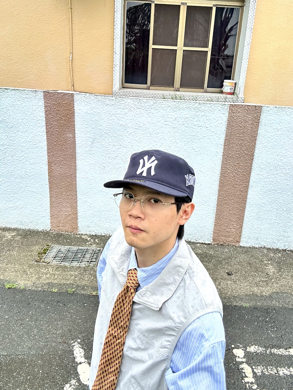 ブルー系のその他パンツ、グレー系のナイロンジャケット、ブラウン系のネクタイを着用したメンズの秋コーディネートの3枚目の写真