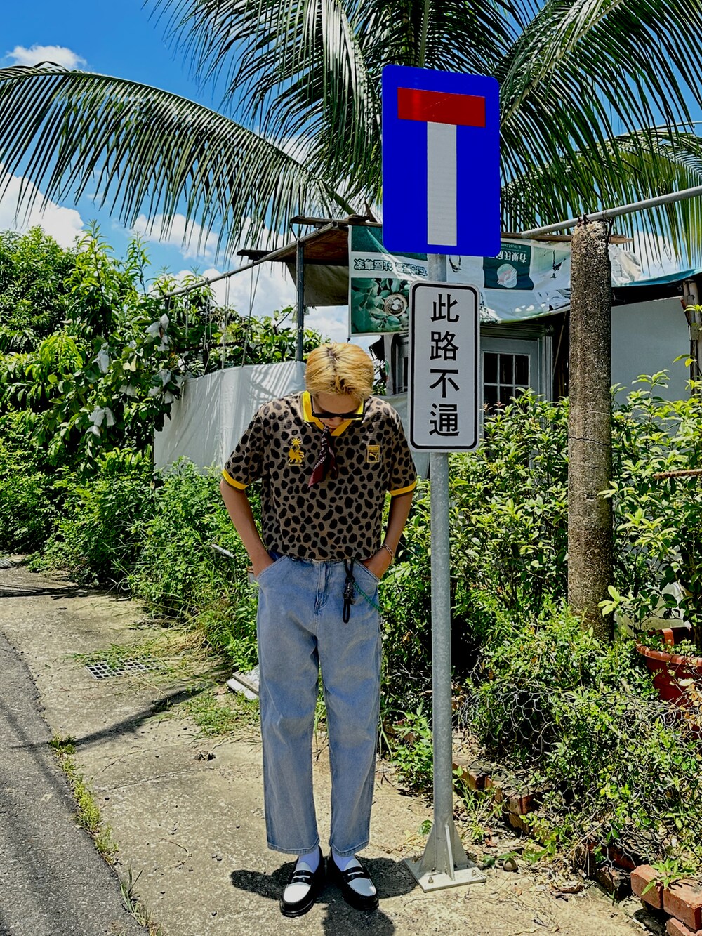 イエロー系のポロシャツ、ブルー系のデニムパンツ、ブラック系のローファーを着用したメンズの夏コーディネートの4枚目の写真