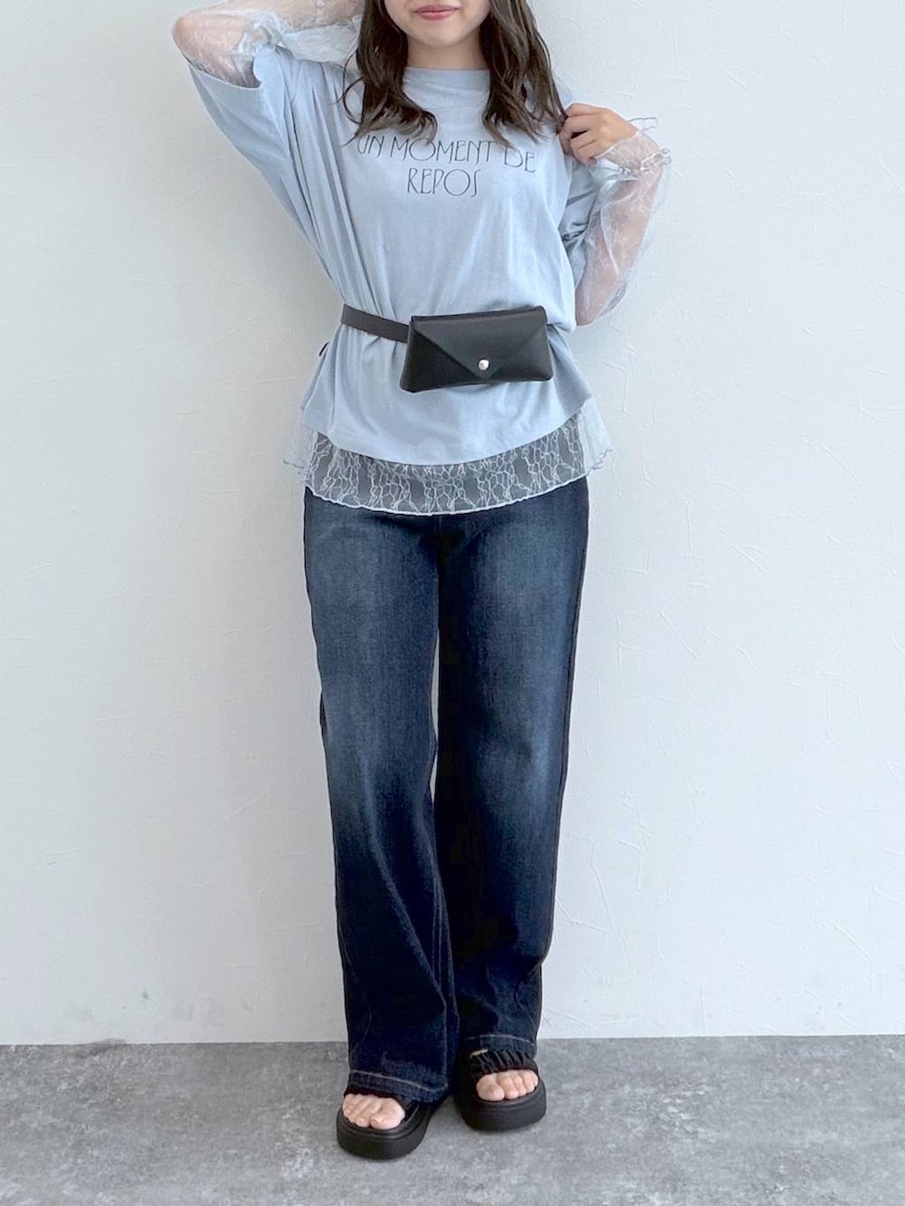 ブラック系のサンダル、ブルー系のデニムパンツ、ブルー系のTシャツ/カットソーを着用したレディースの秋コーディネートの3枚目の写真