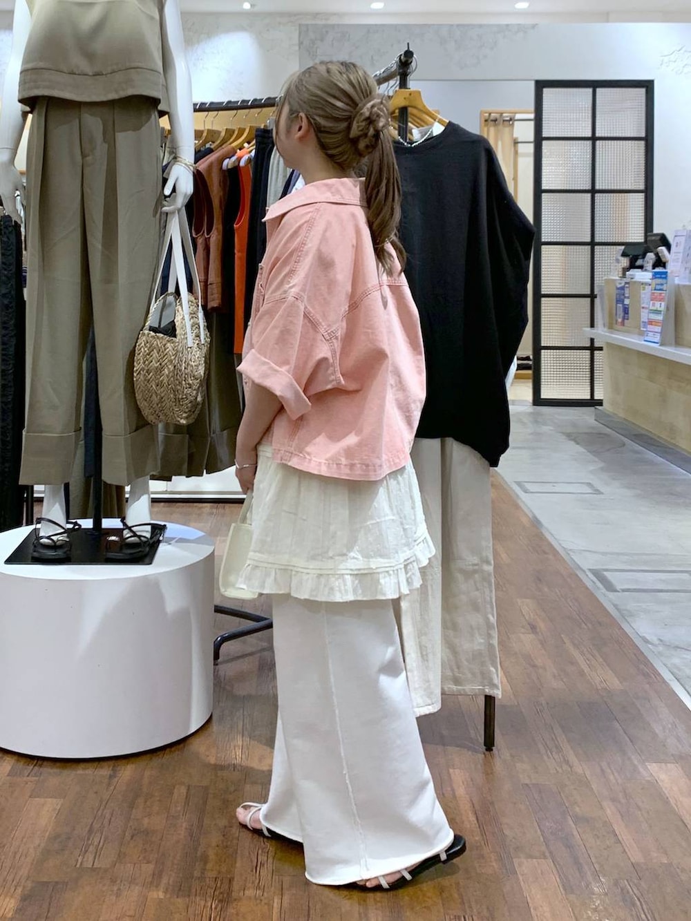 ホワイト系のスウェットパンツ、ホワイト系のサンダル、ホワイト系のショルダーバッグを着用したレディースの夏コーディネートの3枚目の写真