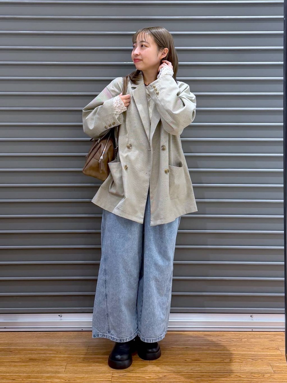 ブラック系のサンダル、ブラウン系のボストンバッグ、ホワイト系のTシャツ/カットソーを着用したレディースの春コーディネートの4枚目の写真