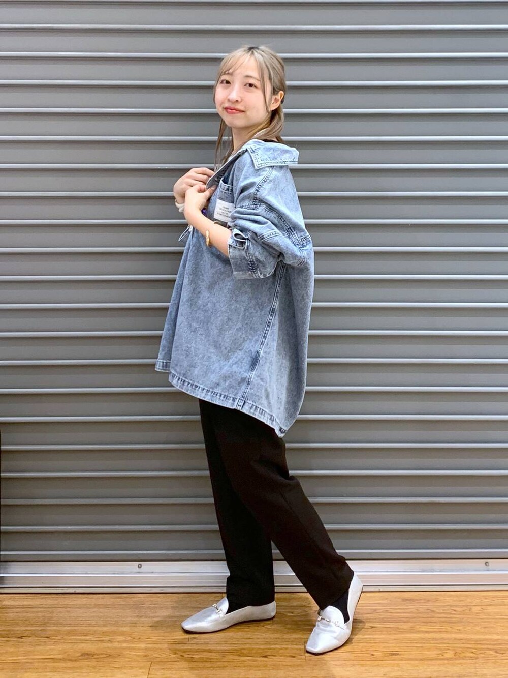 ブラック系のTシャツ/カットソー、ブラック系のスーツパンツ、シルバー系のローファーを着用したレディースの冬コーディネートの3枚目の写真