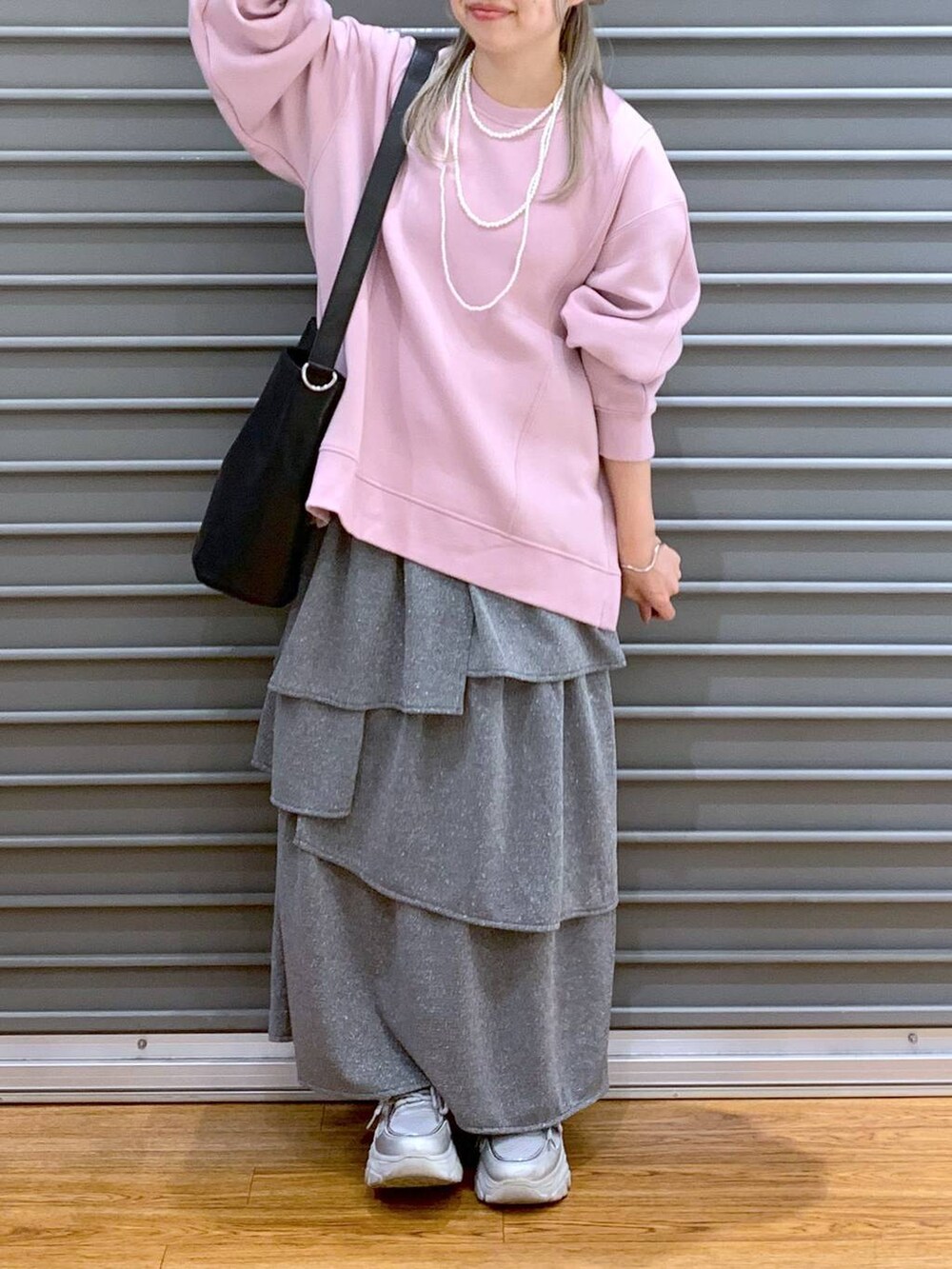 ブラック系のショルダーバッグ、ピンク系のスウェット、シルバー系のスニーカーを着用したレディースの秋コーディネートの6枚目の写真