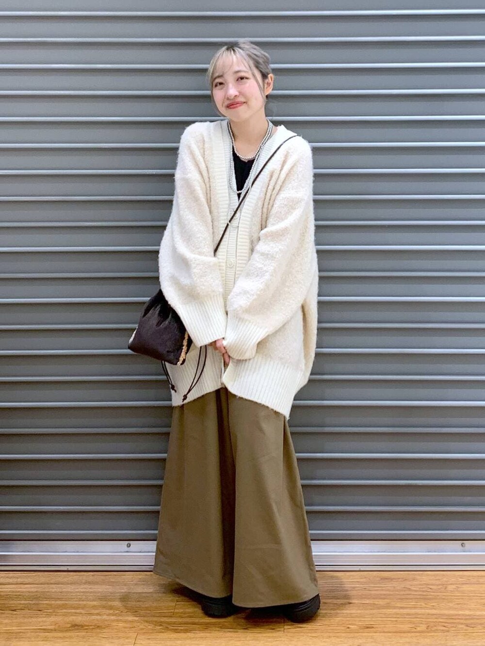 ブラウン系のその他パンツ、ホワイト系のカーディガン/ボレロ、ブラウン系のショルダーバッグを着用したレディースの秋コーディネートの4枚目の写真