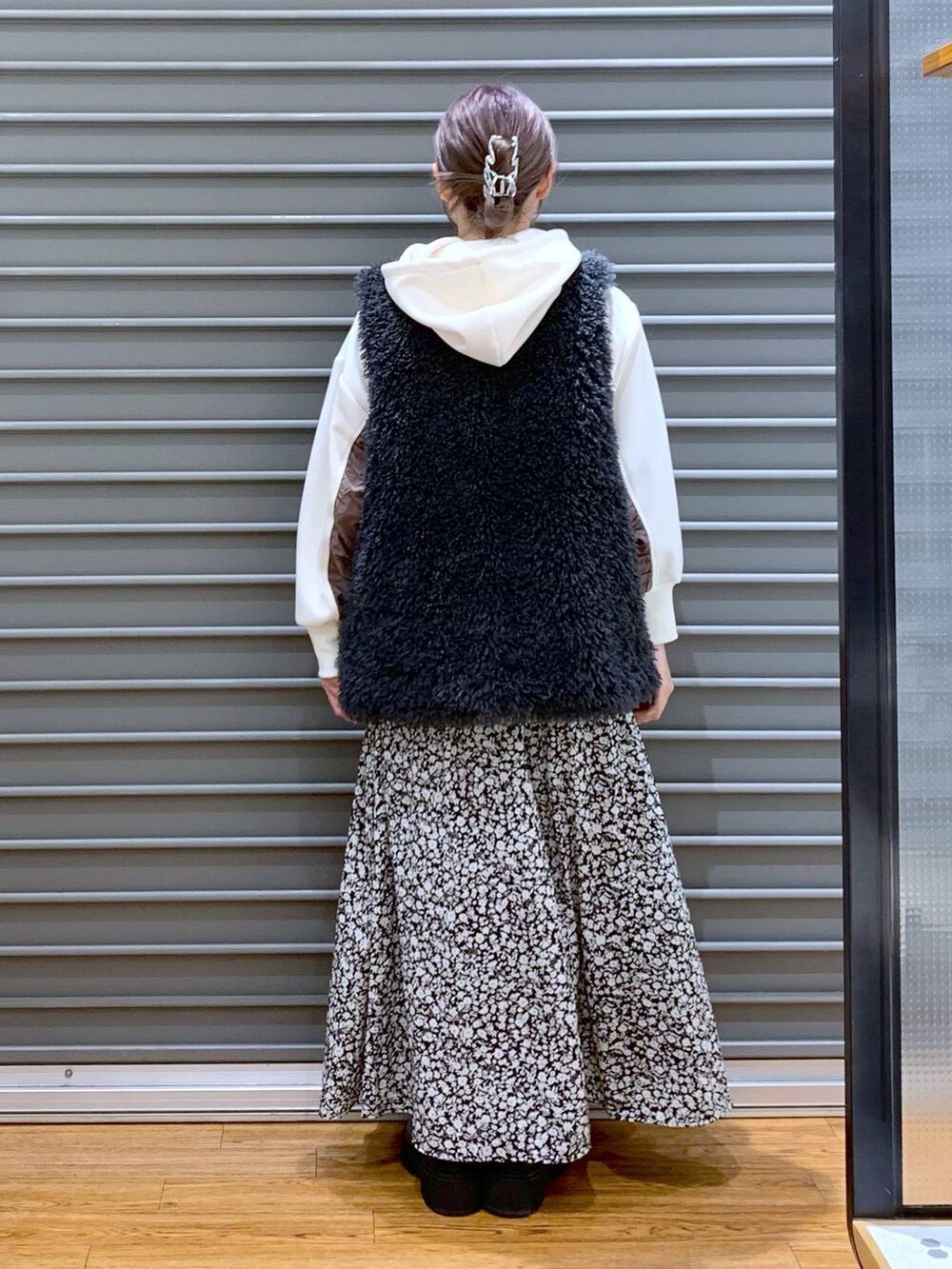 ブラック系のブーツ、ホワイト系のショルダーバッグ、ホワイト系のパーカーを着用したレディースの秋コーディネートの2枚目の写真