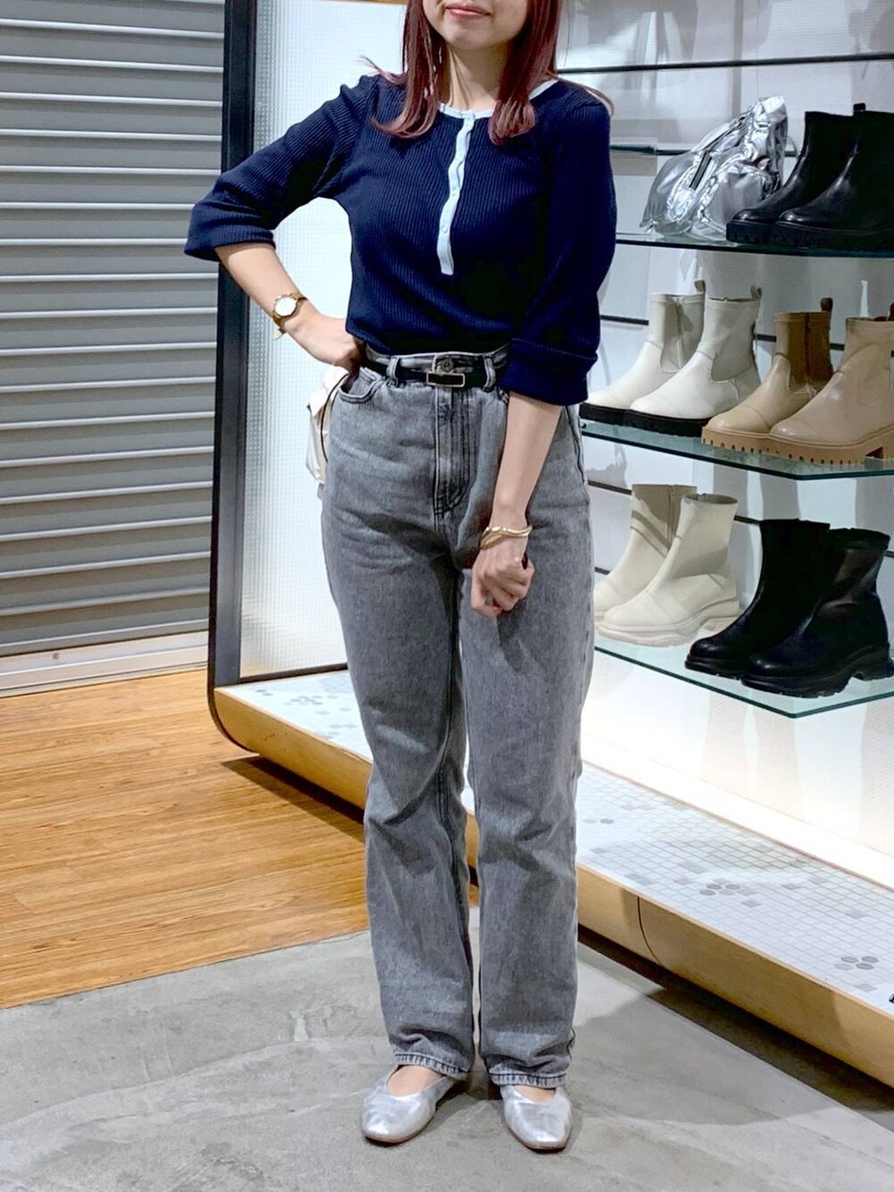 シルバー系のショルダーバッグ、シルバー系のパンプス、グレー系のデニムパンツを着用したレディースの秋コーディネートの6枚目の写真