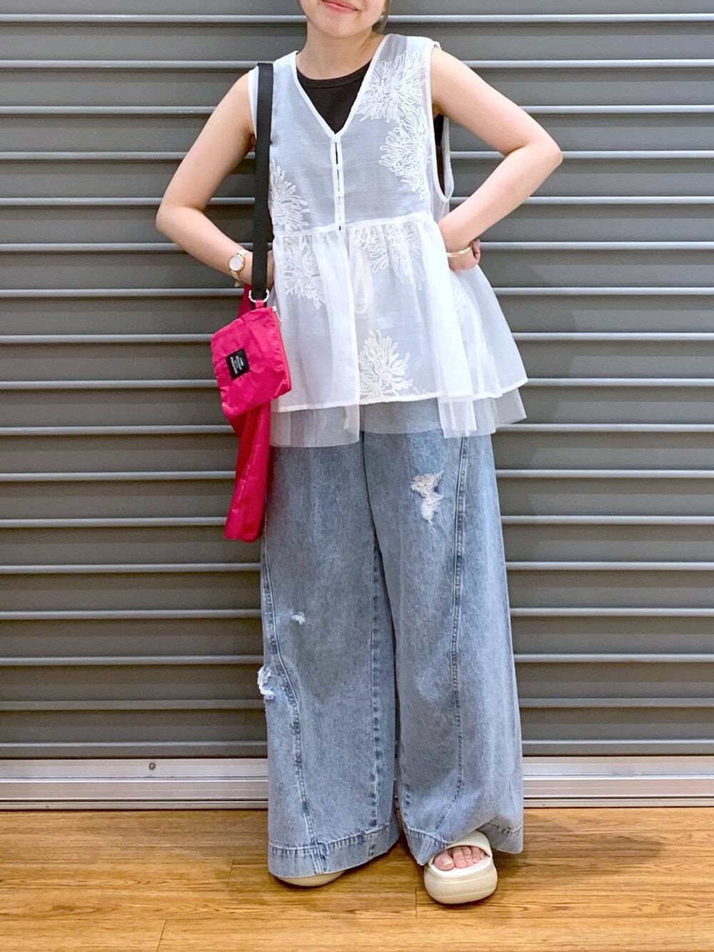 ブラック系のタンクトップ、ブルー系のデニムパンツ、ホワイト系のシャツ/ブラウスを着用したレディースの夏コーディネートの4枚目の写真