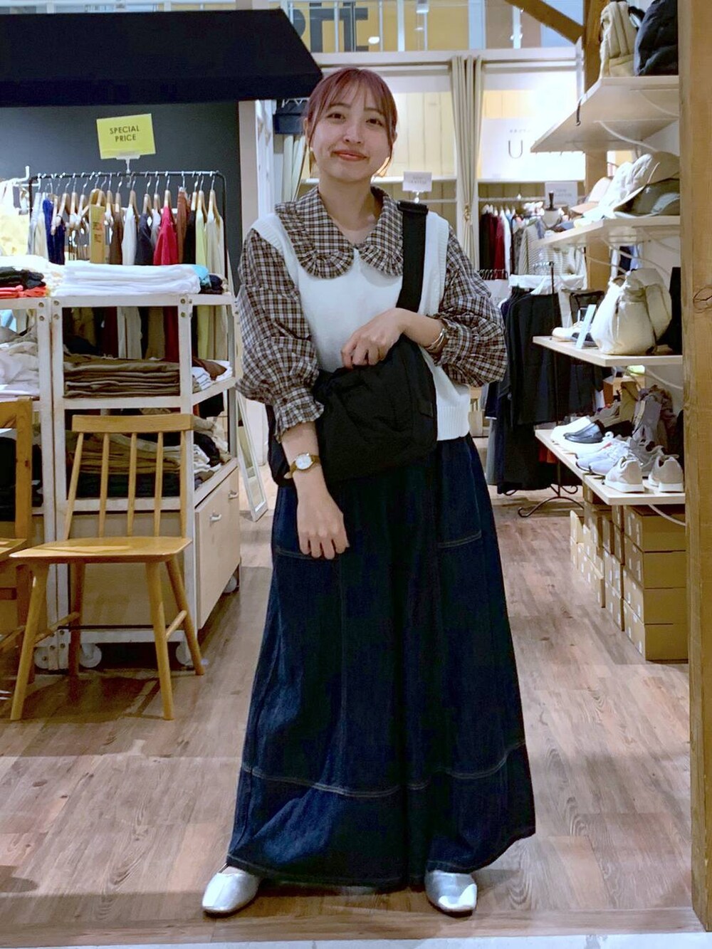 ホワイト系のベスト、ブルー系のデニムパンツ、その他のパンプスを着用したレディースの秋コーディネートの5枚目の写真