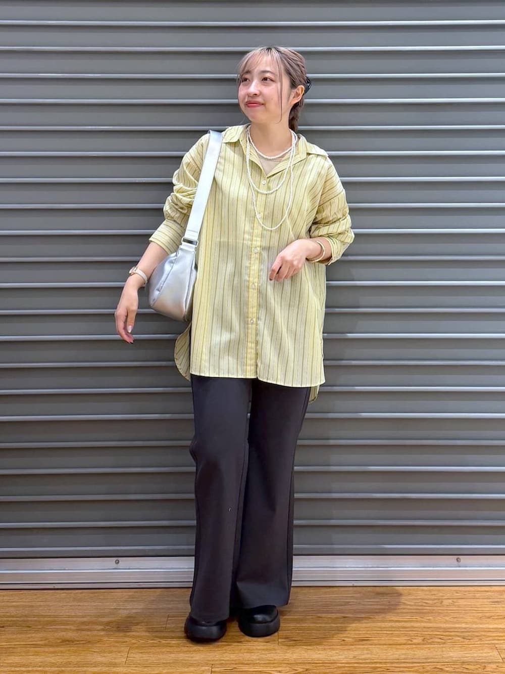 ブラック系のサンダル、グレー系のその他パンツ、イエロー系のシャツ/ブラウスを着用したレディースの春コーディネートの4枚目の写真