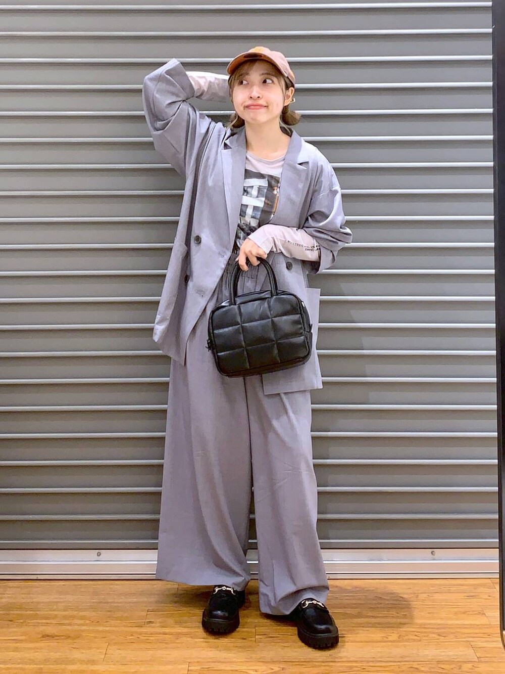 グレー系のスラックス、ブラック系のローファー、グレー系のテーラードジャケットを着用したレディースの夏コーディネートの6枚目の写真