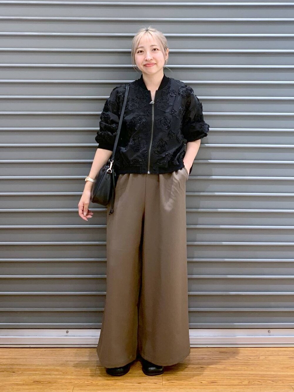 ブラウン系のその他パンツ、ブラック系のその他シューズ、ブラック系のショルダーバッグを着用したレディースの秋コーディネートの4枚目の写真