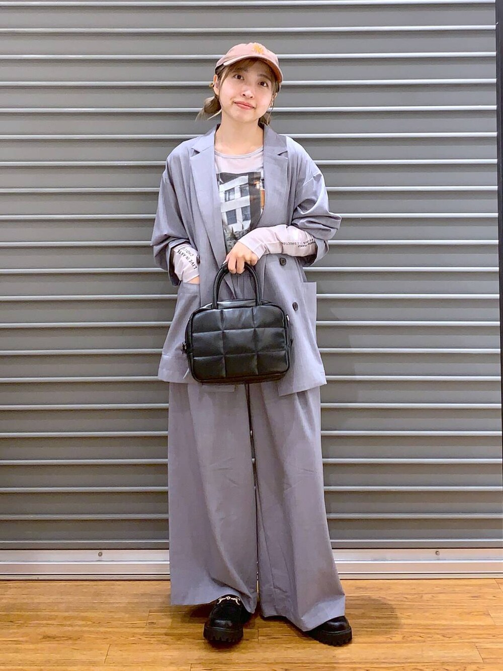 グレー系のスラックス、ブラック系のローファー、グレー系のテーラードジャケットを着用したレディースの夏コーディネートの4枚目の写真