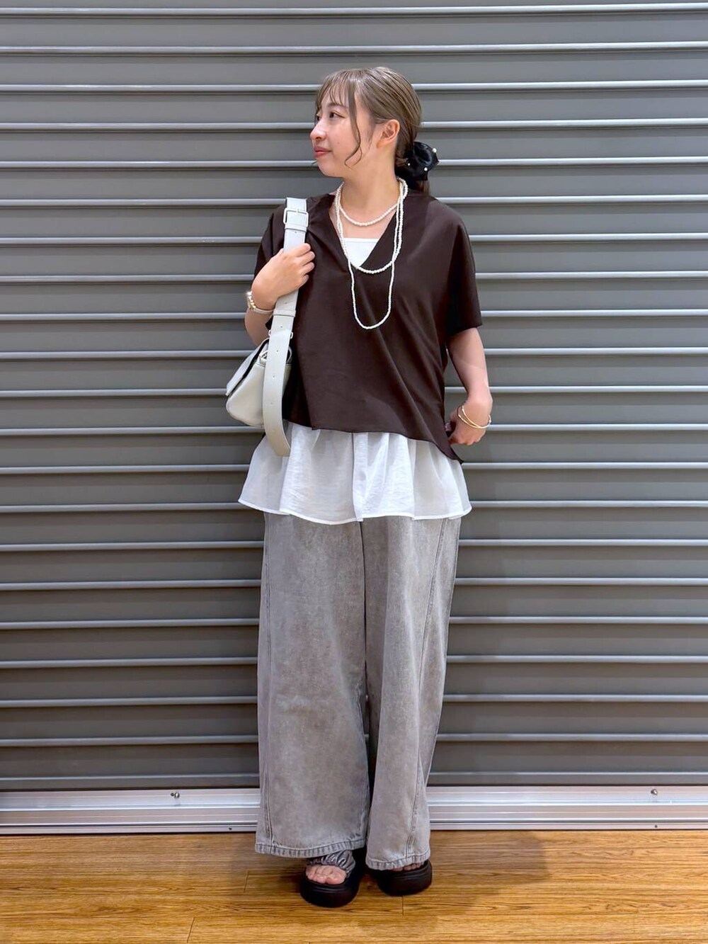 グレー系のショルダーバッグ、グレー系のデニムパンツ、その他のサンダルを着用したレディースの夏コーディネートの5枚目の写真