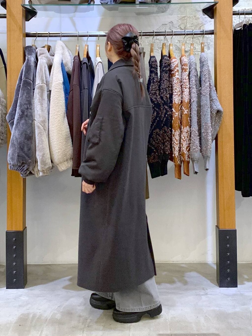 ブラック系のブーツ、ブラック系のショルダーバッグ、グレー系のその他アウターを着用したレディースの冬コーディネートの4枚目の写真