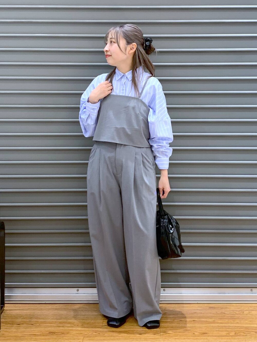 ブルー系のシャツ/ブラウス、グレー系のその他パンツ、ブラック系のパンプスを着用したレディースの春コーディネートの5枚目の写真