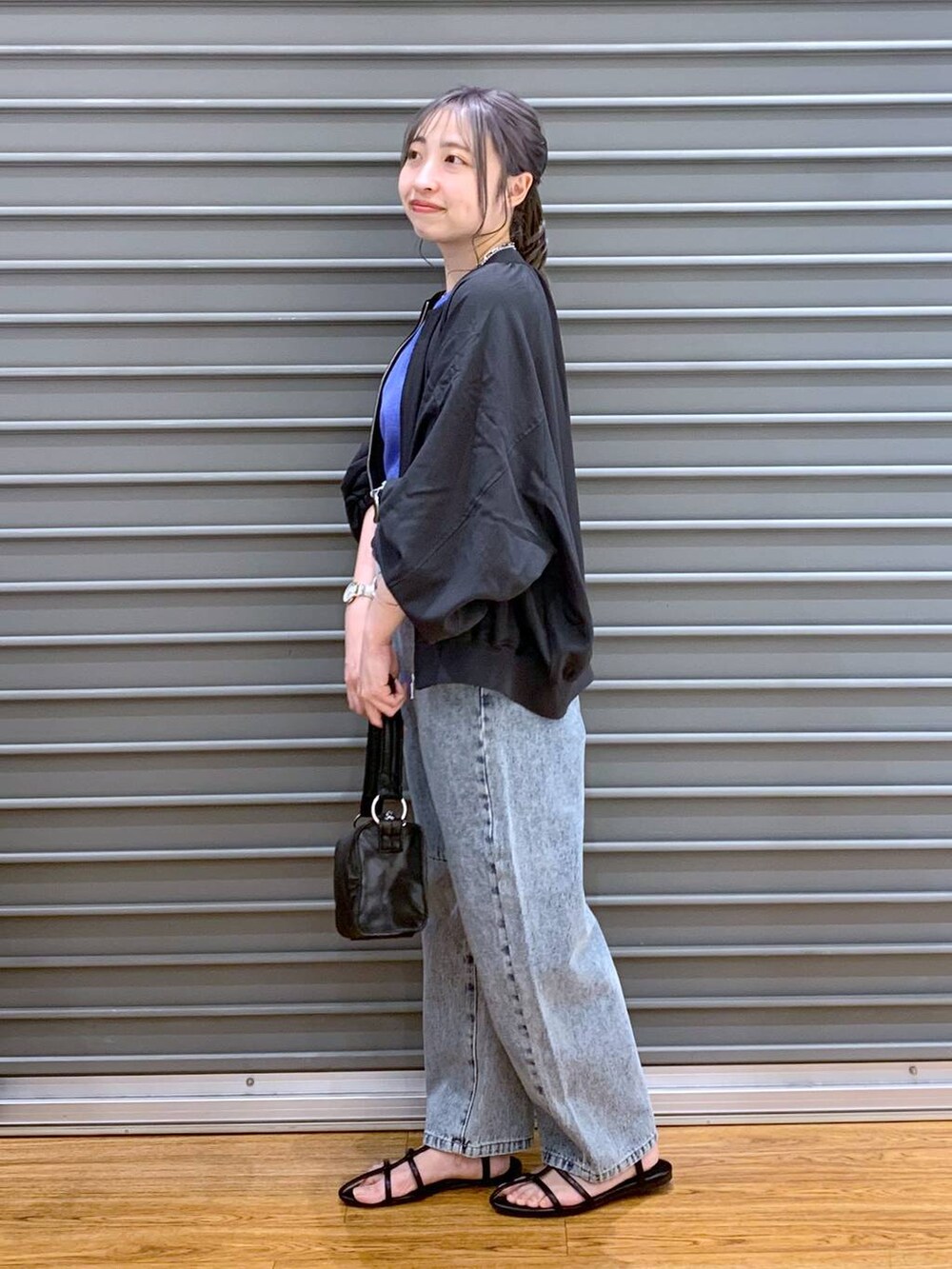 ブルー系のデニムパンツ、パープル系のTシャツ/カットソー、グレー系のブルゾンを着用したレディースの春コーディネートの3枚目の写真