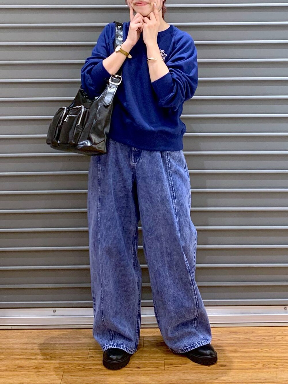 ブラック系のブーツ、ブラック系のショルダーバッグ、ブルー系のスウェットを着用したレディースの冬コーディネートの5枚目の写真