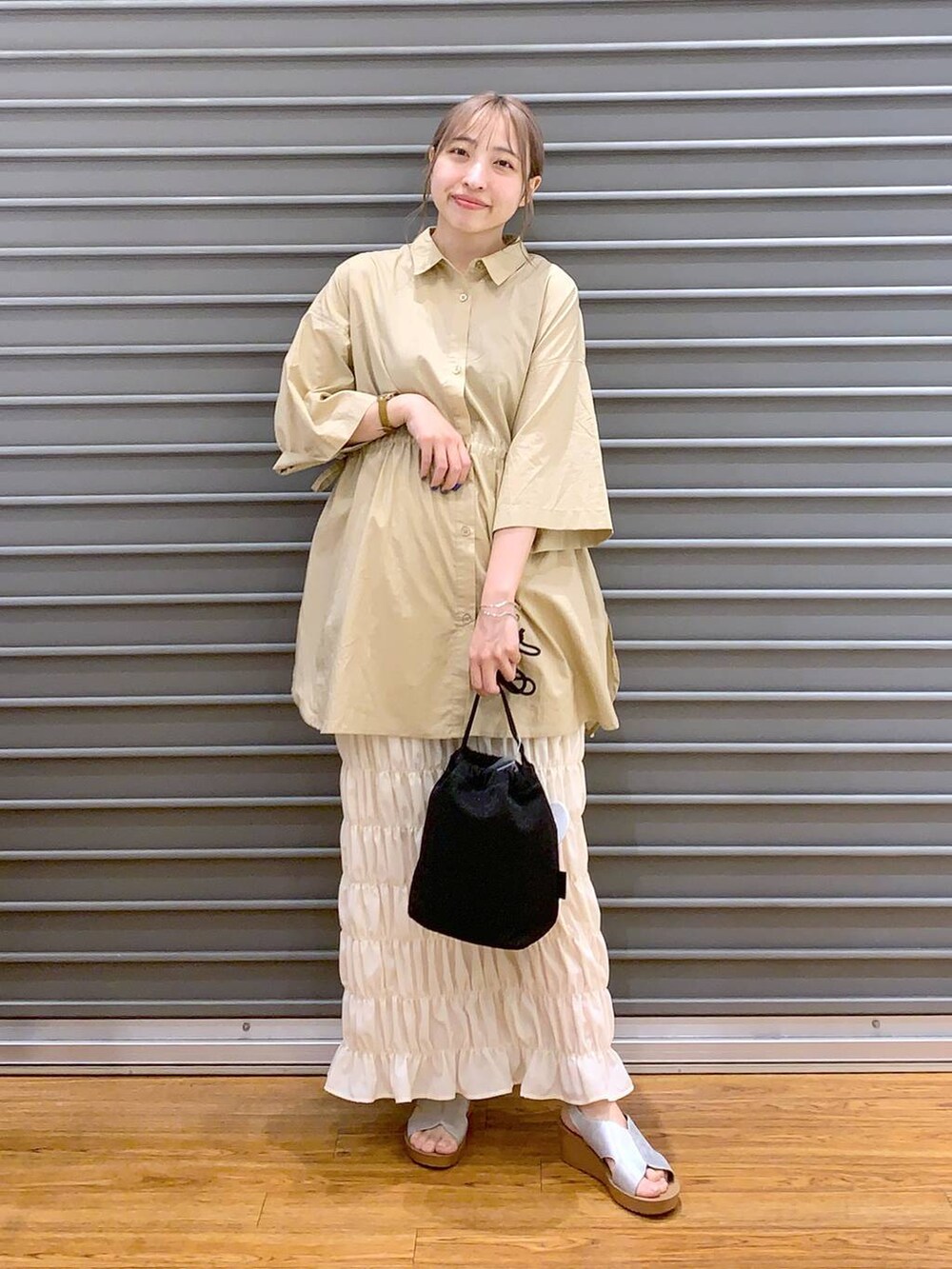 ベージュ系のその他トップス、ホワイト系のスカート、シルバー系のサンダルを着用したレディースの夏コーディネートの3枚目の写真