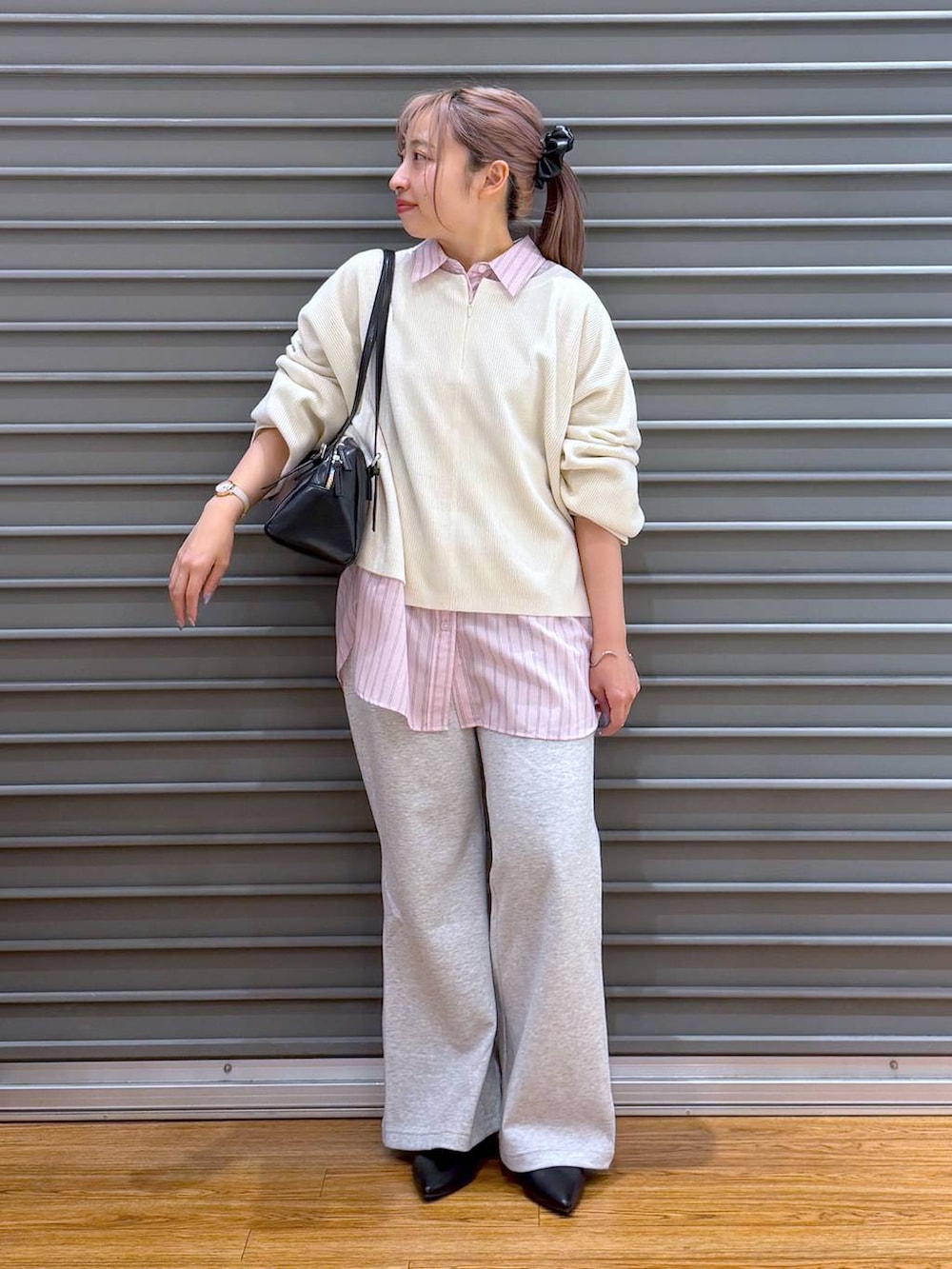 ホワイト系のニット/セーター、ブラック系のボストンバッグ、ブラック系のパンプスを着用したレディースの冬コーディネートの6枚目の写真