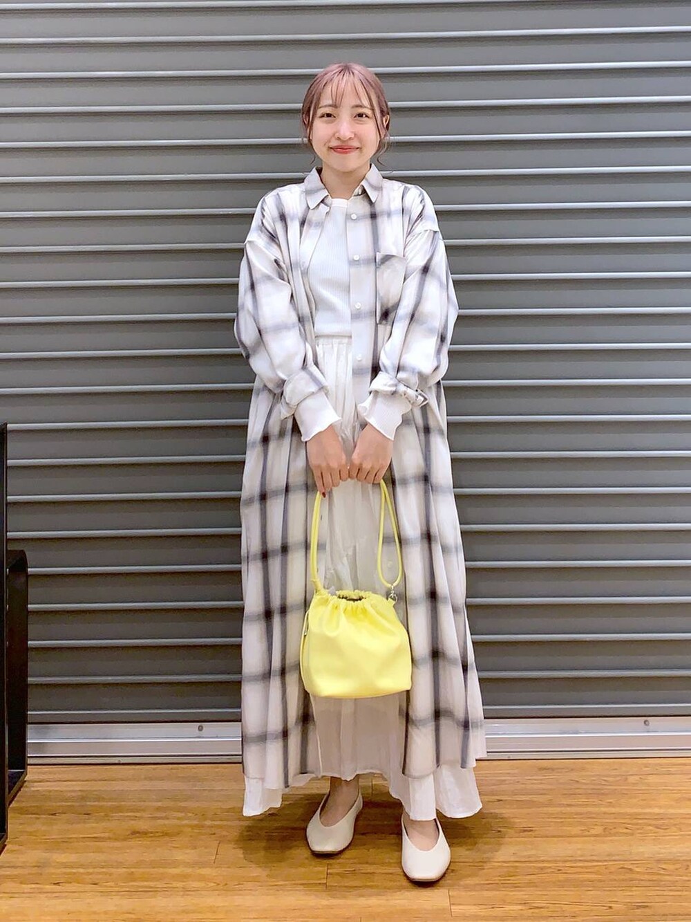 イエロー系のショルダーバッグ、ホワイト系のパンプス、ホワイト系のTシャツ/カットソーを着用したレディースの春コーディネートの7枚目の写真