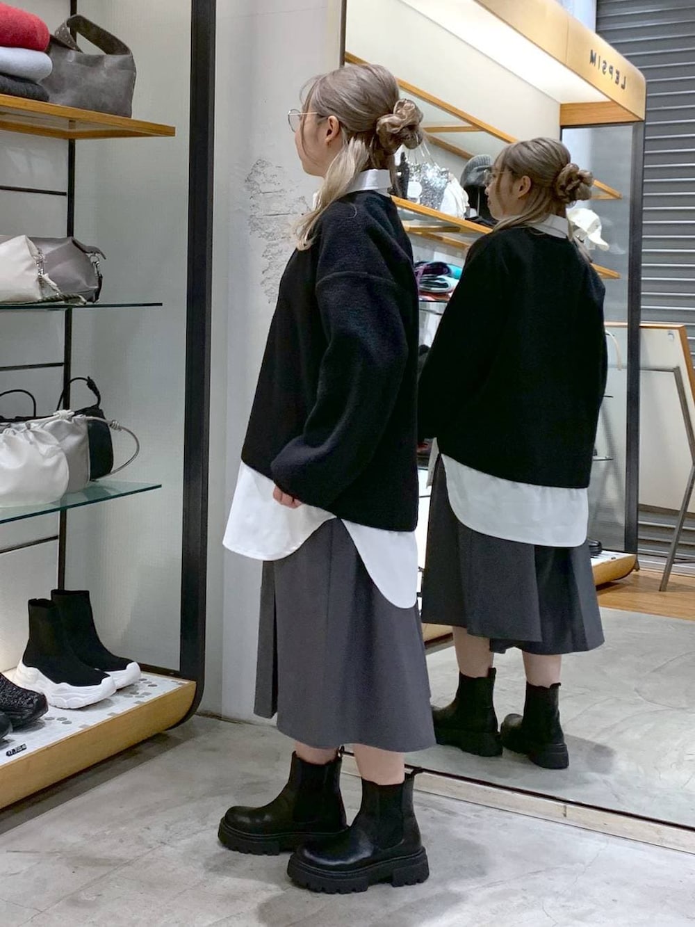 ブラック系のブーツ、ブラック系のトートバッグ、グレー系のその他パンツを着用したレディースの冬コーディネートの3枚目の写真