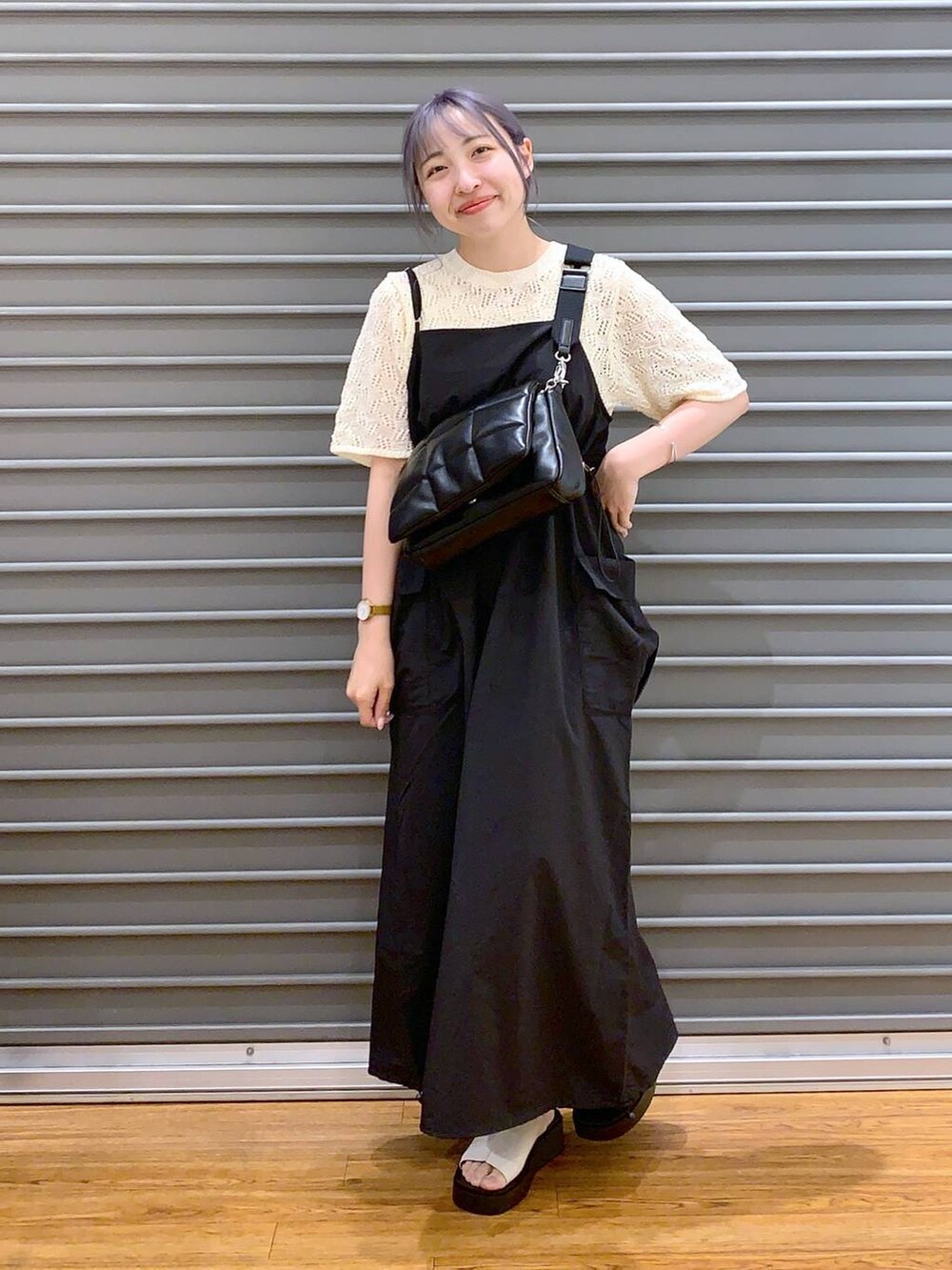 ブラック系のショルダーバッグ、ブラック系のワンピース、ホワイト系のサンダルを着用したレディースの春コーディネートの6枚目の写真