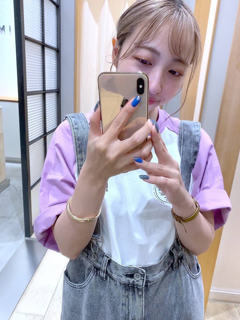 パープル系のTシャツ/カットソー、ホワイト系のサンダル、グレー系のデニムパンツを着用したレディースの夏コーディネートの2枚目の写真