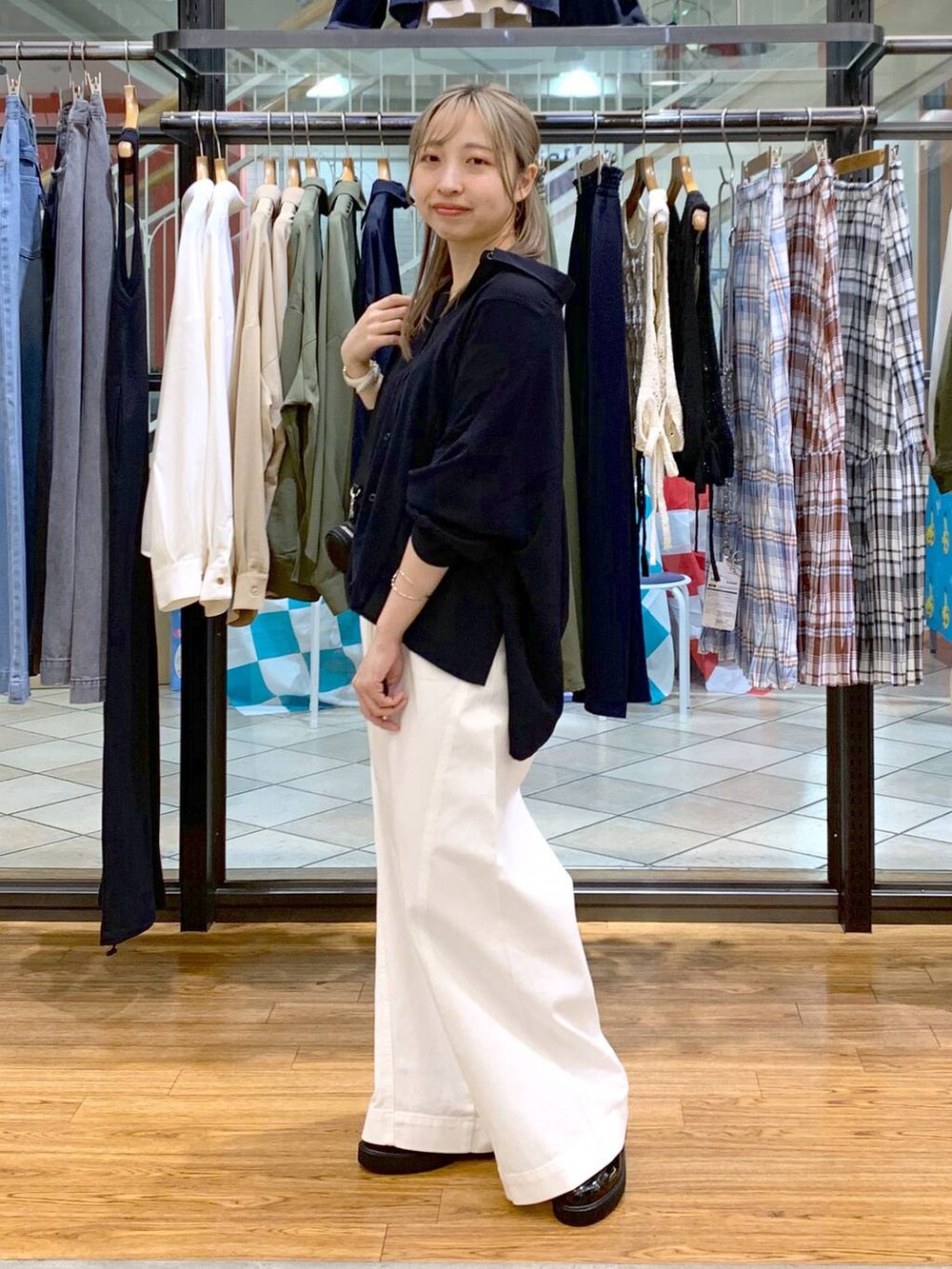 ブルー系のシャツ/ブラウス、ブラック系のローファー、ホワイト系のデニムパンツを着用したレディースの春コーディネートの3枚目の写真