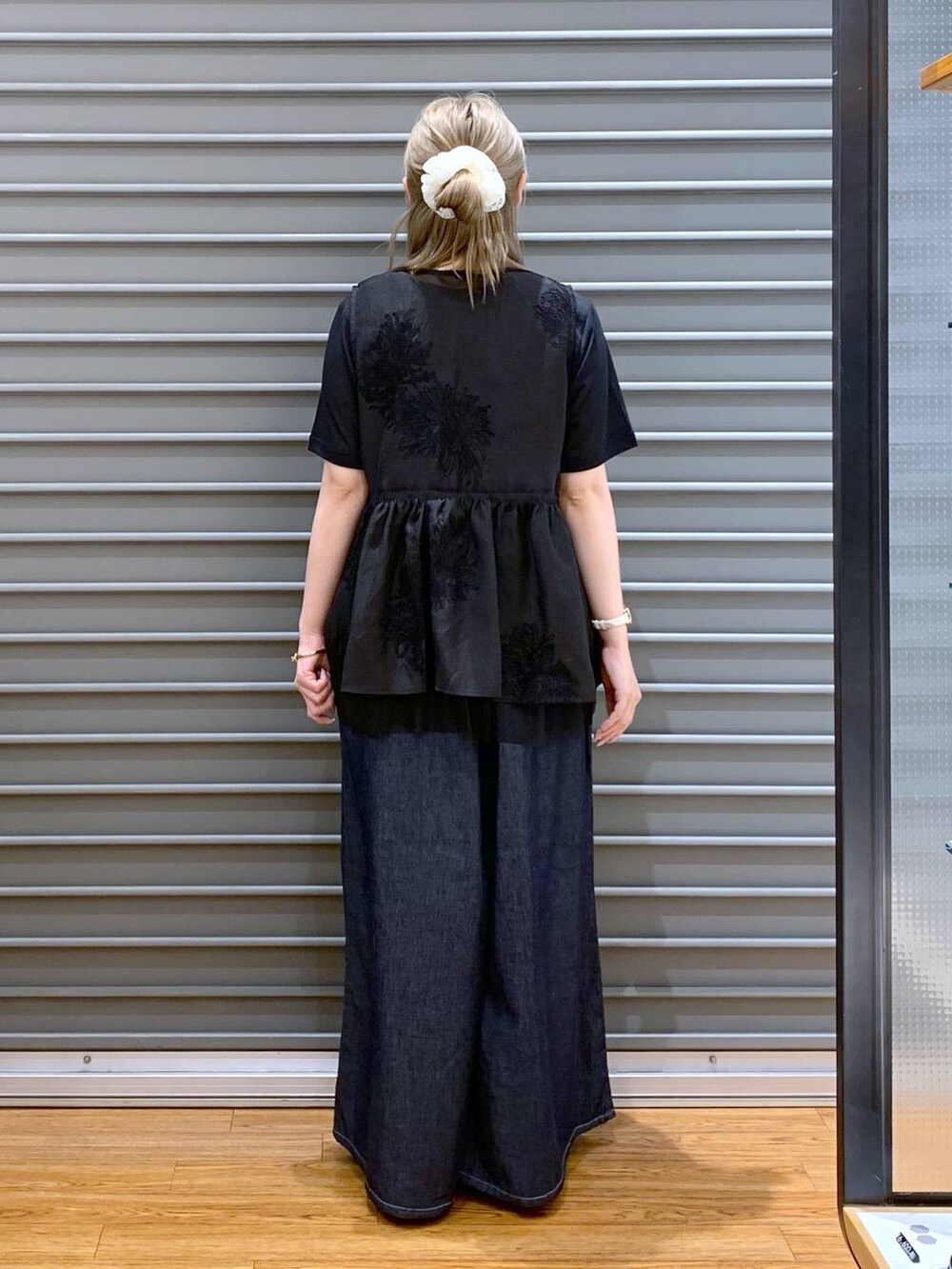 ブラック系のサンダル、ブルー系のデニムパンツ、ブラック系のシャツ/ブラウスを着用したレディースの夏コーディネートの2枚目の写真