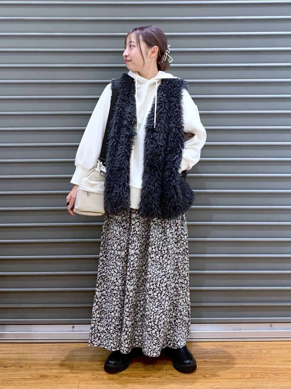 ブラック系のブーツ、ホワイト系のショルダーバッグ、ホワイト系のパーカーを着用したレディースの秋コーディネートの7枚目の写真