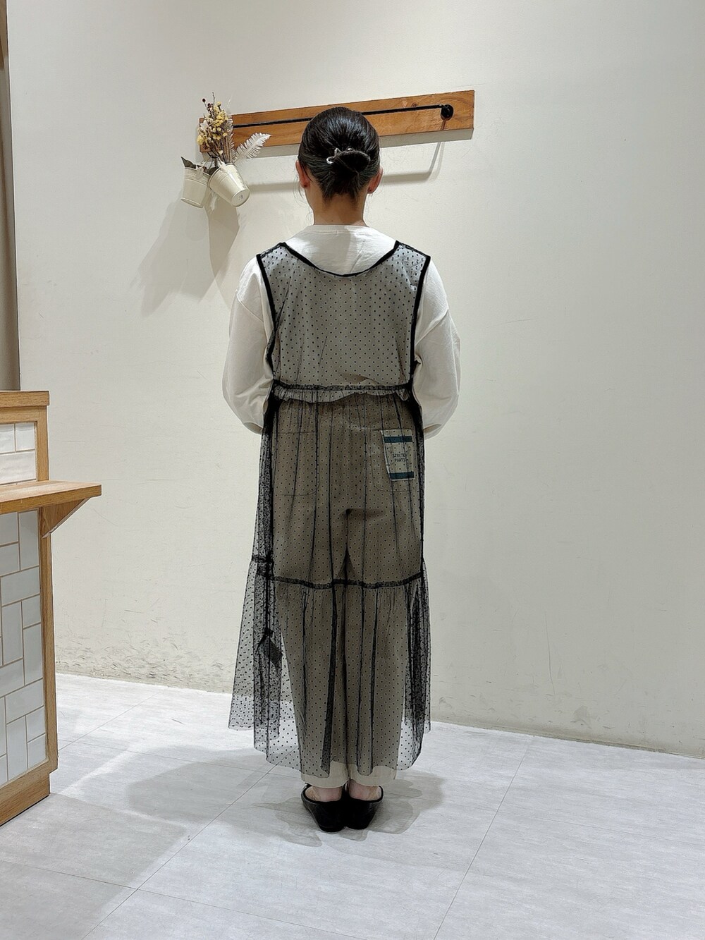 ホワイト系のTシャツ/カットソー、ベージュ系のその他パンツ、ブラック系のワンピースを着用したレディースの秋コーディネートの3枚目の写真