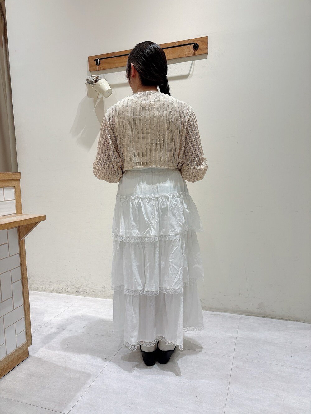 ベージュ系のカーディガン/ボレロ、ホワイト系のスカートを着用したレディースの春コーディネートの3枚目の写真