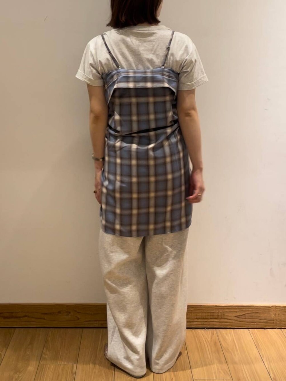 シルバー系のサンダル、グレー系のTシャツ/カットソー、グレー系のデニムパンツを着用したレディースの夏コーディネートの2枚目の写真