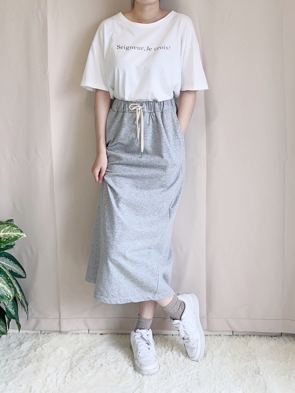 ホワイト系のシューズ、ブルー系のキャップを着用したレディースの春コーディネートの2枚目の写真