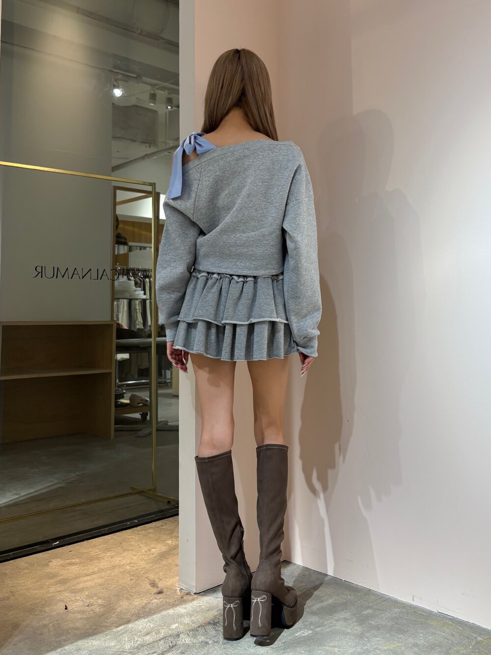 グレー系のスウェット、グレー系のその他パンツ、ブラウン系のブーツを着用したレディースの秋コーディネートの2枚目の写真