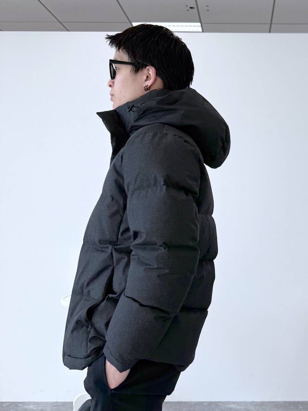 グレー系のダウンジャケット/コート、ブラック系のその他パンツ、ホワイト系のスウェットを着用したメンズの秋コーディネートの7枚目の写真