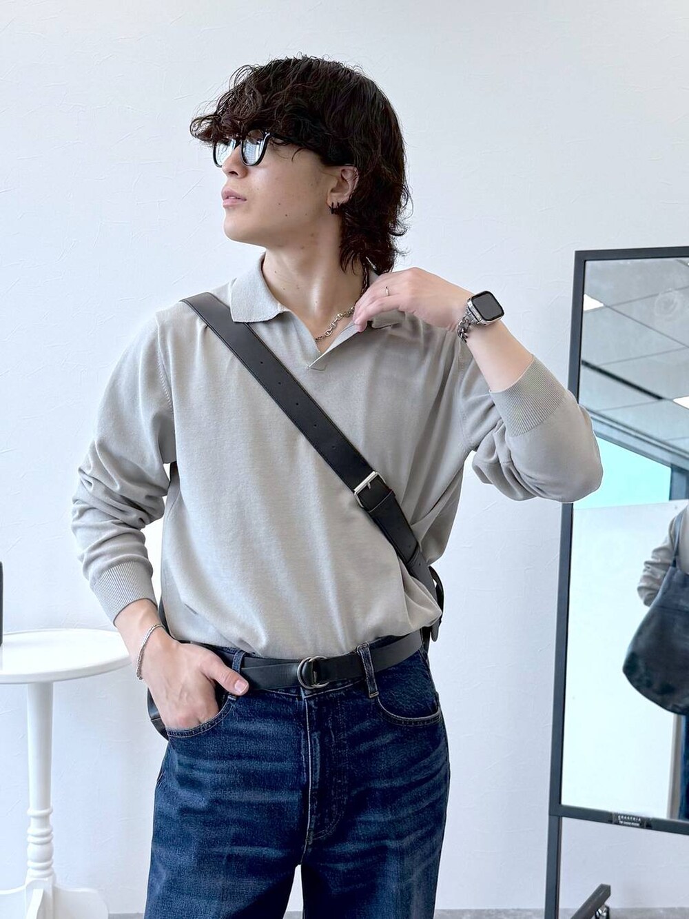 ブルー系のデニムパンツ、ベージュ系のニット/セーター、ブラック系のその他シューズを着用したメンズの秋コーディネートの5枚目の写真